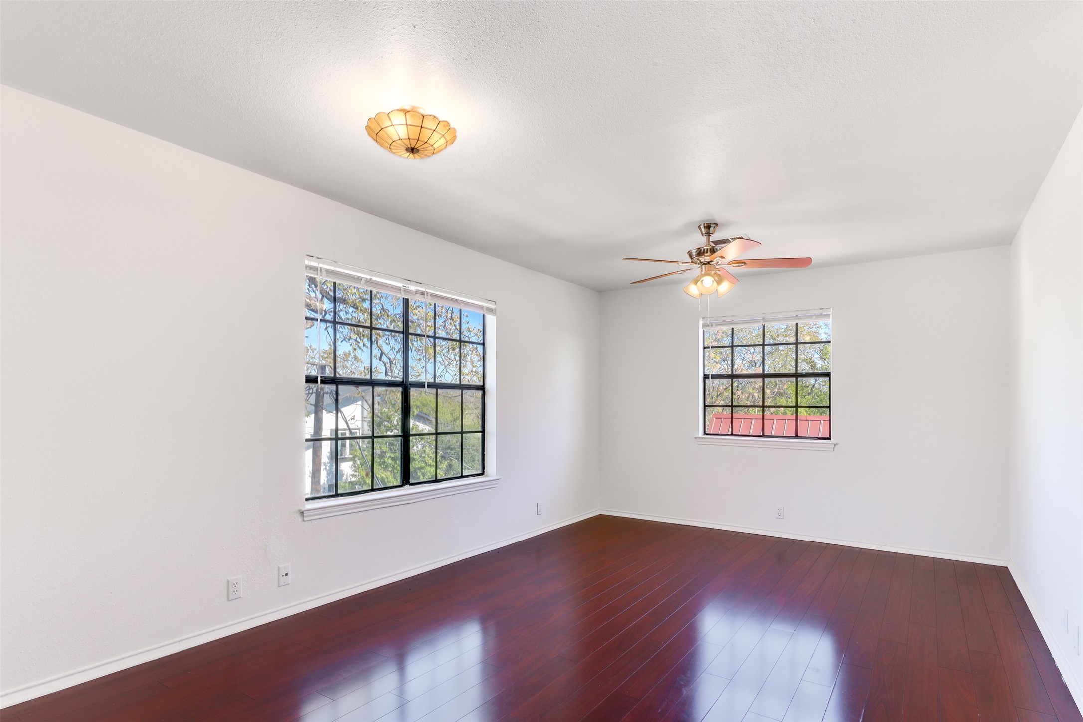 1903 East 20th Street Austin, TX 78722 - Photo 4 of 13 an empty room with windows and ceiling fan