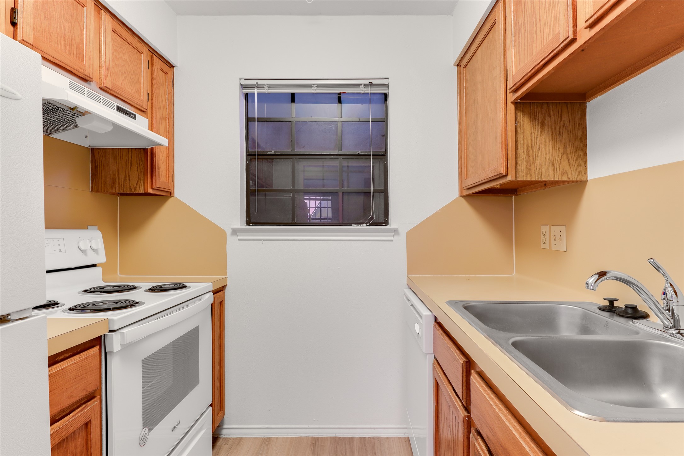 1903 East 20th Street Austin, TX 78722 - Photo 6 of 13 a kitchen with stainless steel appliances granite countertop a sink and a stove