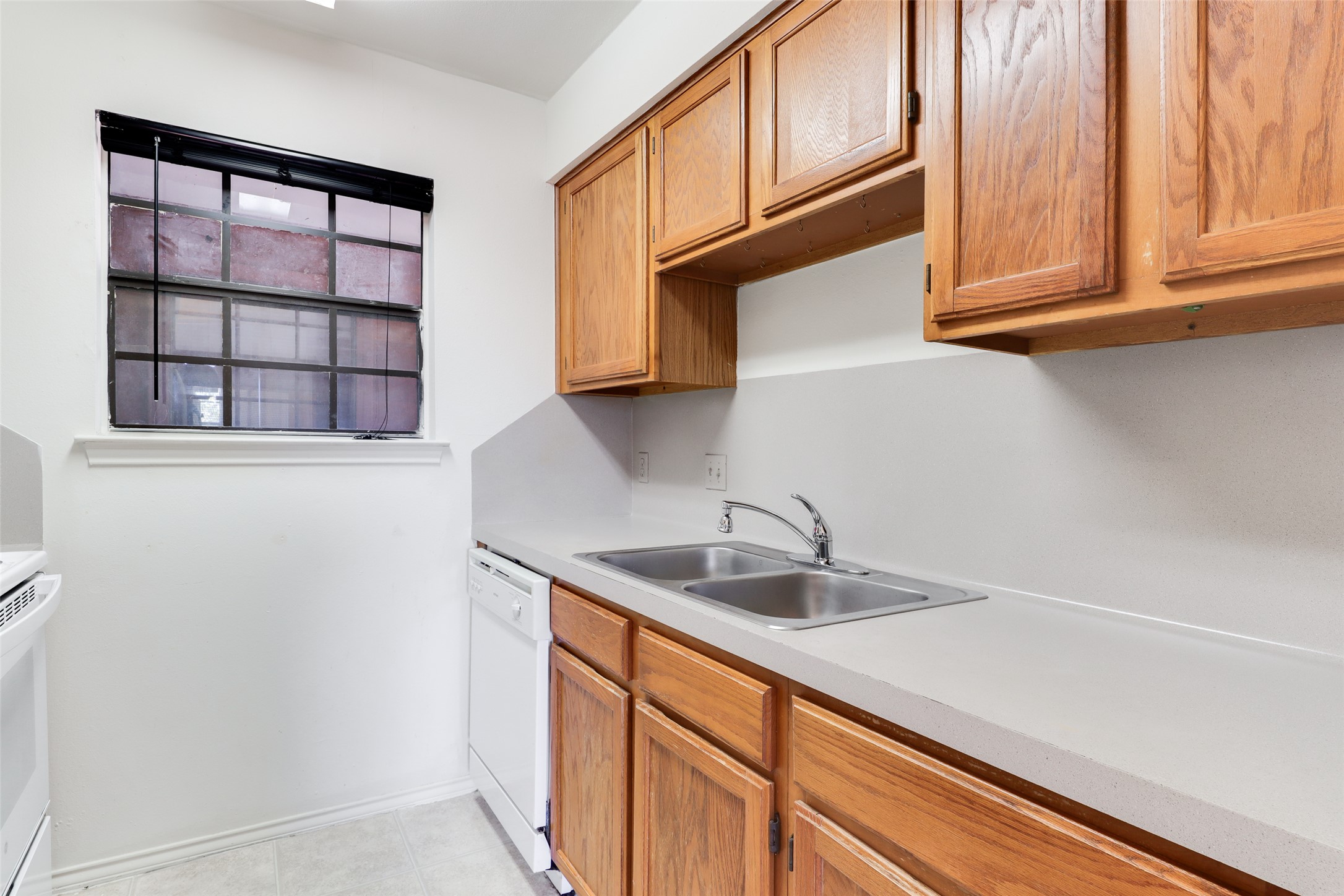 1903 East 20th Street Austin, TX 78722 - Photo 7 of 13 a kitchen with stainless steel appliances granite countertop a sink and dishwasher