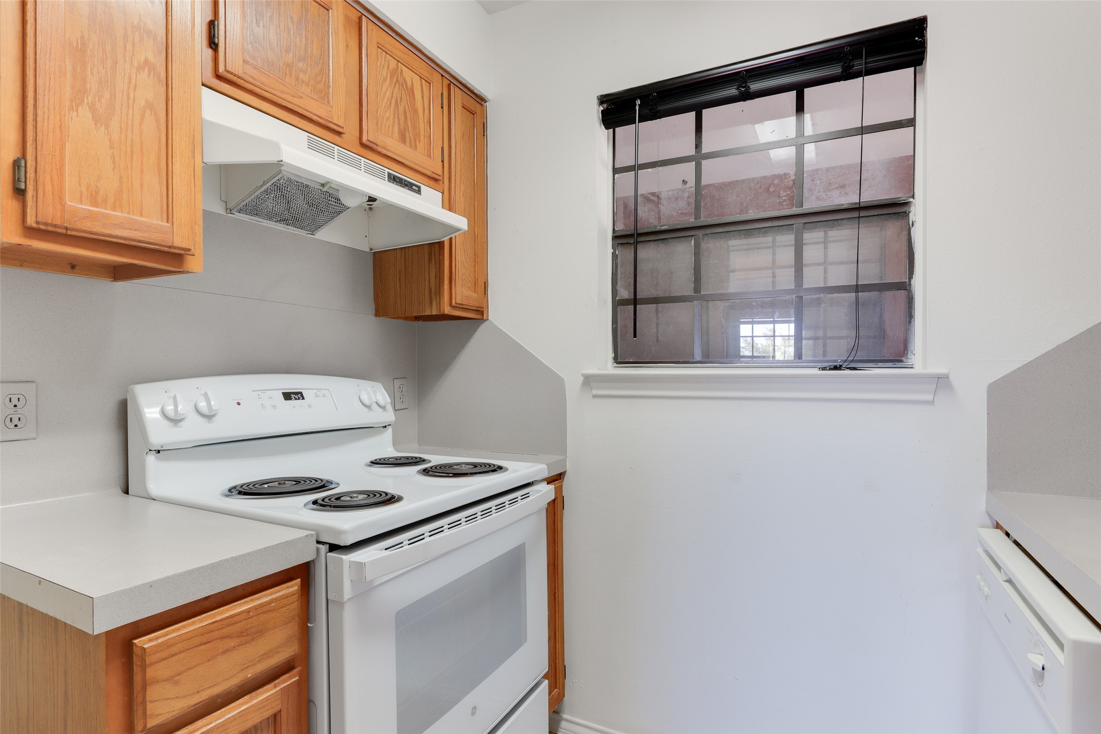 1903 East 20th Street Austin, TX 78722 - Photo 8 of 13 a kitchen with a stove and a microwave