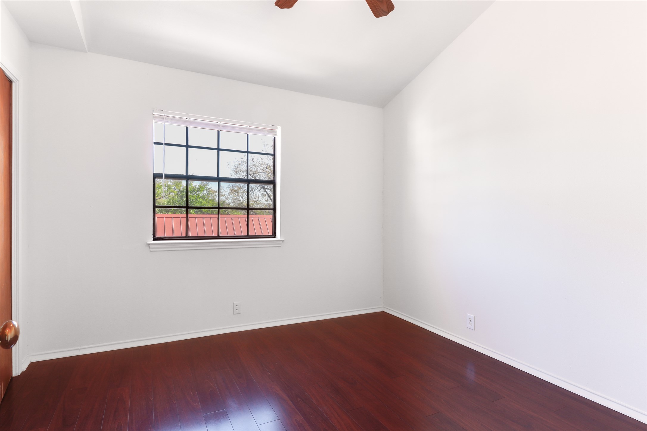 1903 East 20th Street Austin, TX 78722 - Photo 9 of 13 an empty room with wooden floor and windows