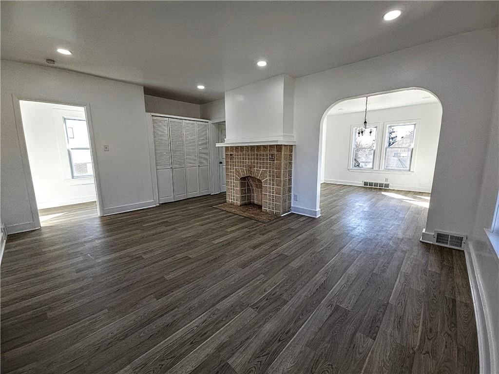 10200 Frankstown Road Pittsburgh, PA 15235 - Photo 13 of 47 an empty room with wooden floor and a fireplace