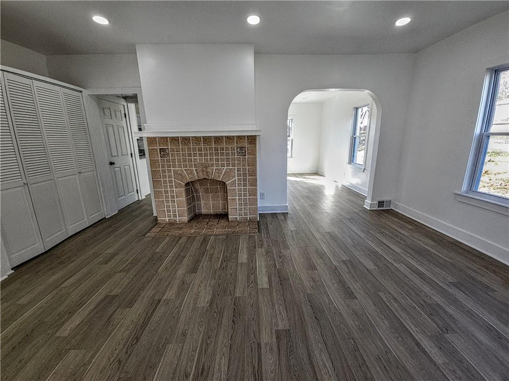 10200 Frankstown Road Pittsburgh, PA 15235 - Photo 14 of 47 an empty room with wooden floor fireplace and windows