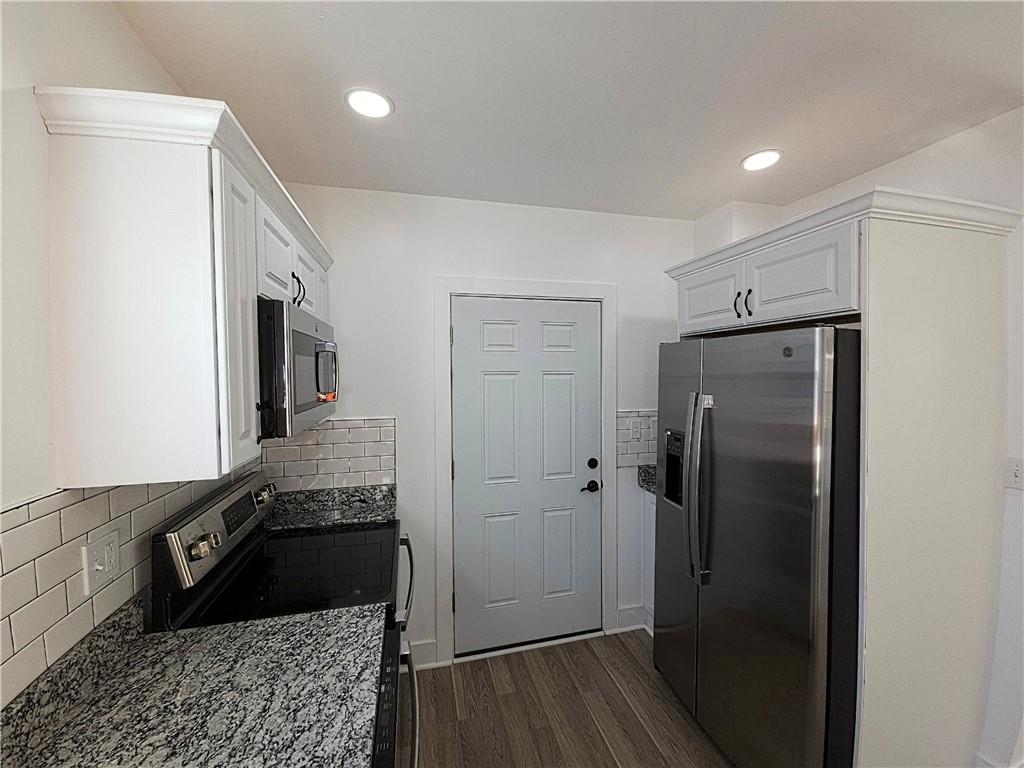 10200 Frankstown Road Pittsburgh, PA 15235 - Photo 23 of 47 a kitchen with a refrigerator and a stove top oven