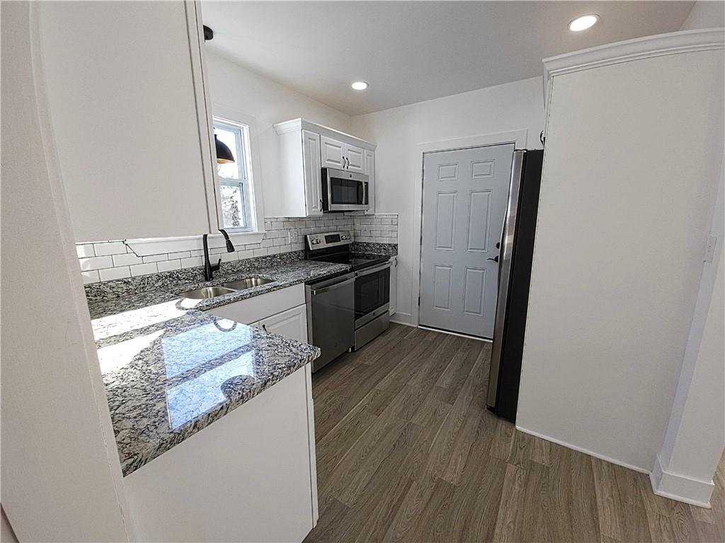 10200 Frankstown Road Pittsburgh, PA 15235 - Photo 24 of 47 a kitchen with stainless steel appliances granite countertop a stove a sink and a refrigerator