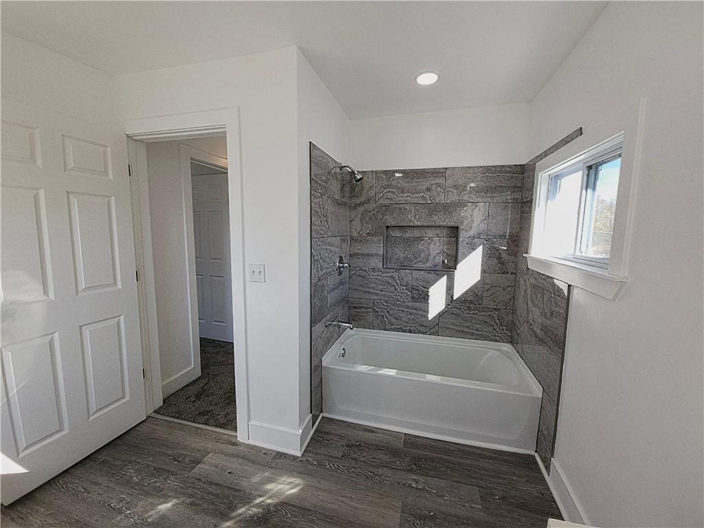 10200 Frankstown Road Pittsburgh, PA 15235 - Photo 30 of 47 a bathroom with a tub shower and hardwood floor