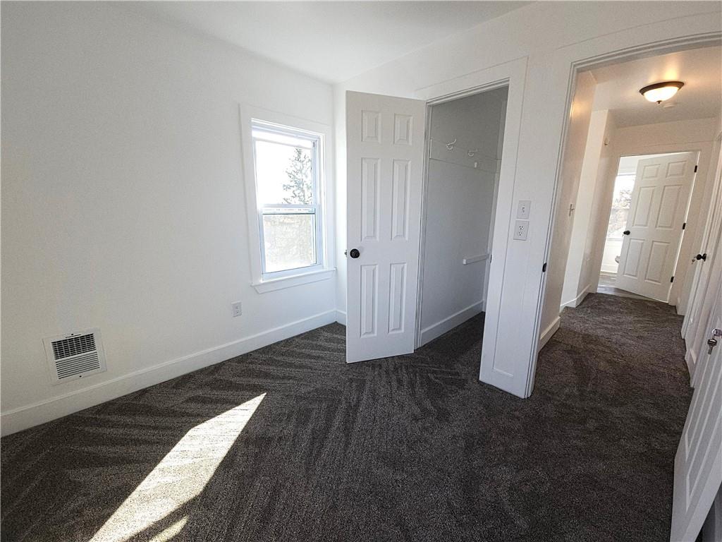 10200 Frankstown Road Pittsburgh, PA 15235 - Photo 37 of 47 an empty room with wooden floor and windows