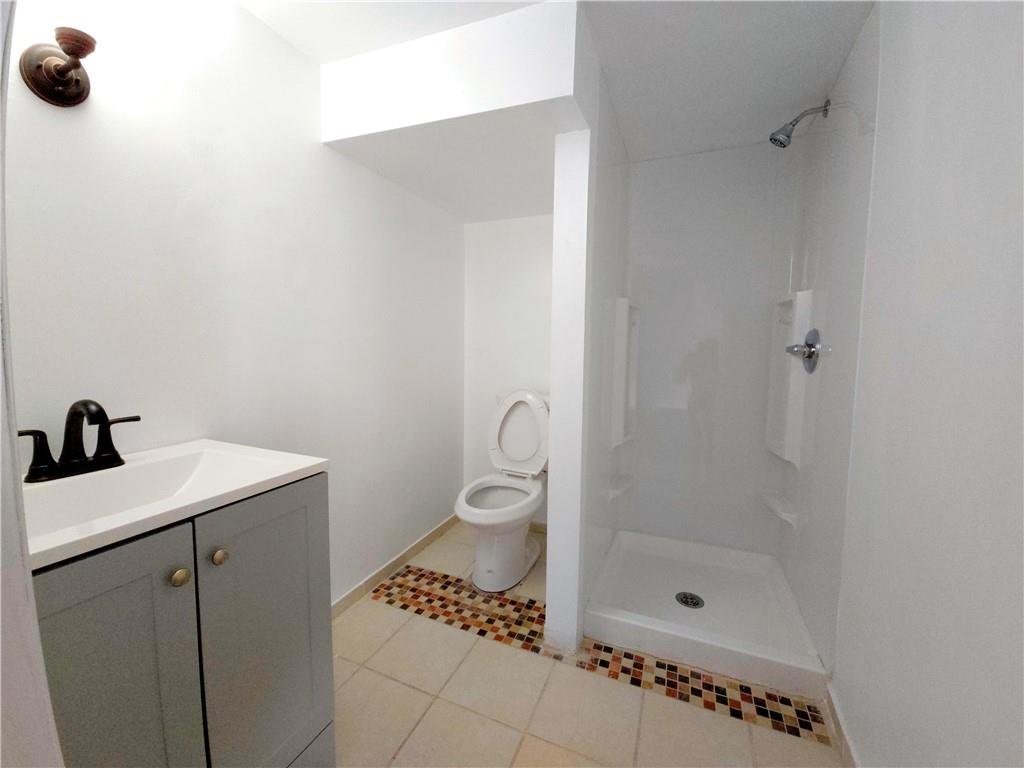 10200 Frankstown Road Pittsburgh, PA 15235 - Photo 44 of 47 a bathroom with a granite countertop sink a mirror and shower