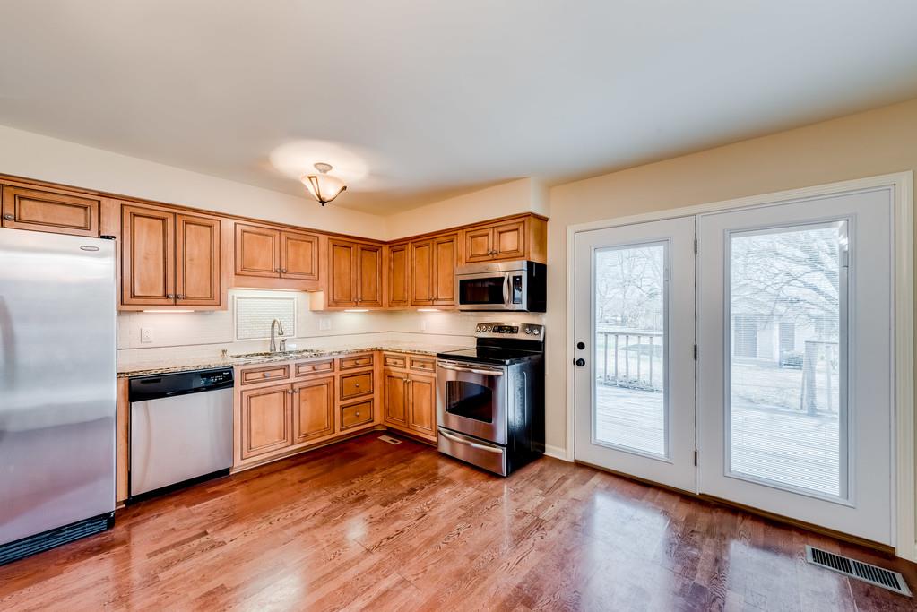 3801 Franklin Road Lebanon, TN 37090 - Photo 11 of 29 a kitchen with stainless steel appliances granite countertop a refrigerator a stove top oven a sink and dishwasher with wooden floor