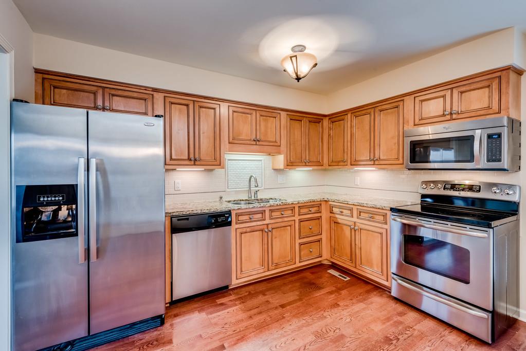 3801 Franklin Road Lebanon, TN 37090 - Photo 10 of 29 a kitchen with stainless steel appliances granite countertop a refrigerator a stove and a sink with wooden floor