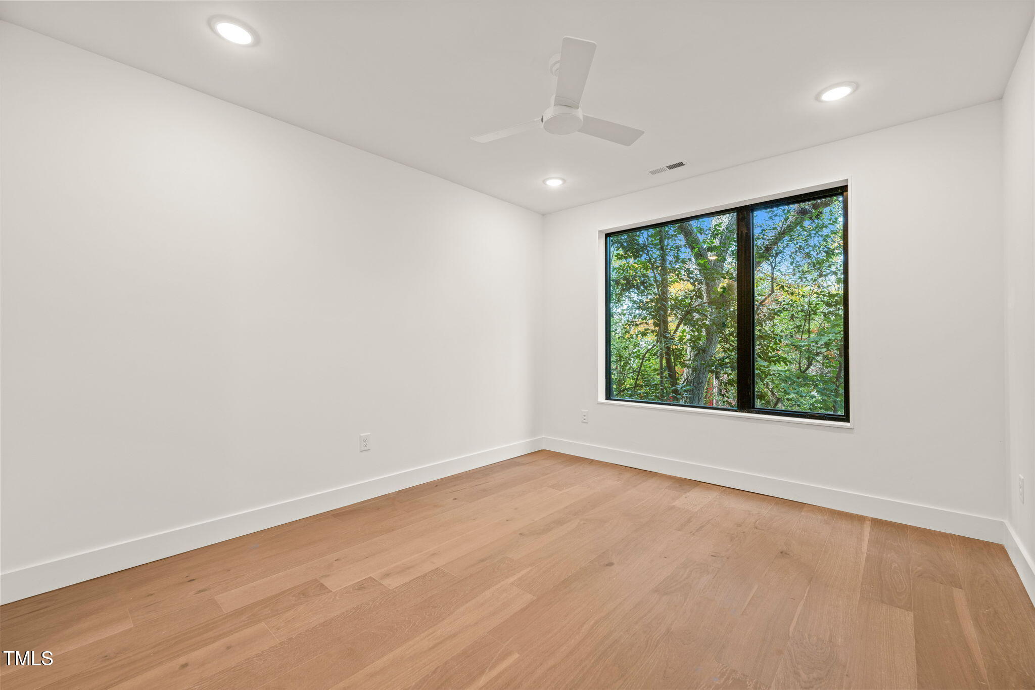 29 Enterprise Street, Unit 209 Raleigh, NC 27607 - Photo 11 of 46 wooden floor in an empty room with a window