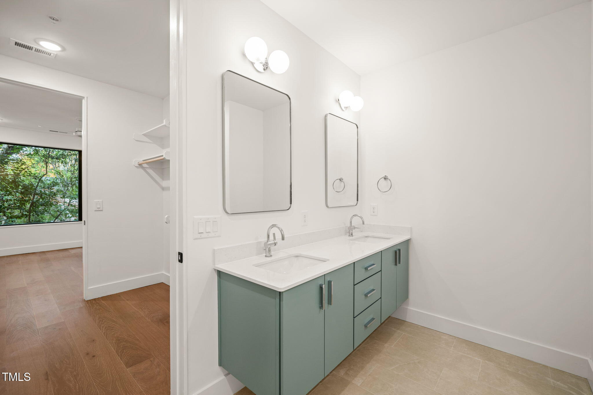 29 Enterprise Street, Unit 209 Raleigh, NC 27607 - Photo 14 of 46 a bathroom with a double vanity sink and mirror