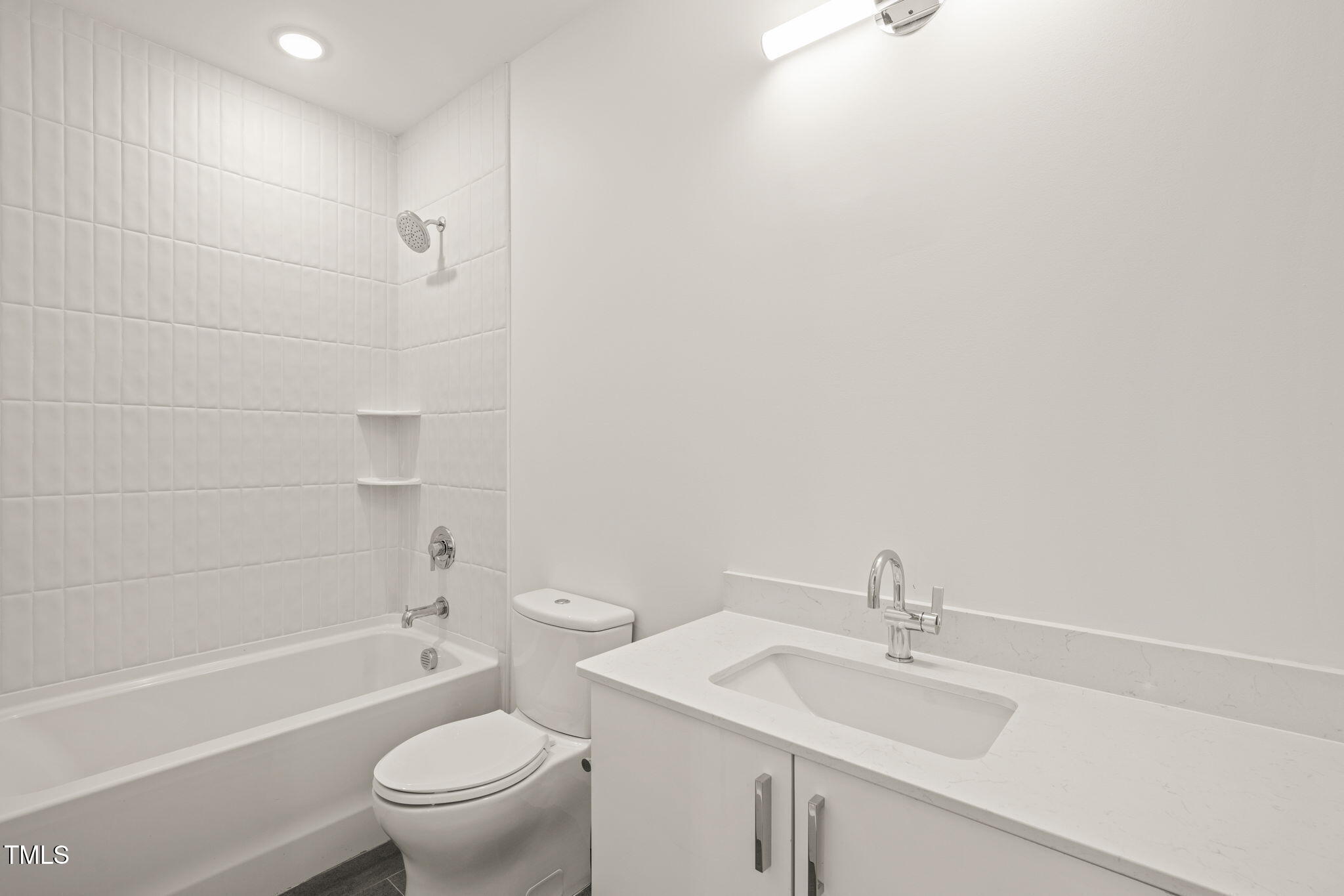 29 Enterprise Street, Unit 209 Raleigh, NC 27607 - Photo 15 of 46 a bathroom with a sink toilet vanity and shower
