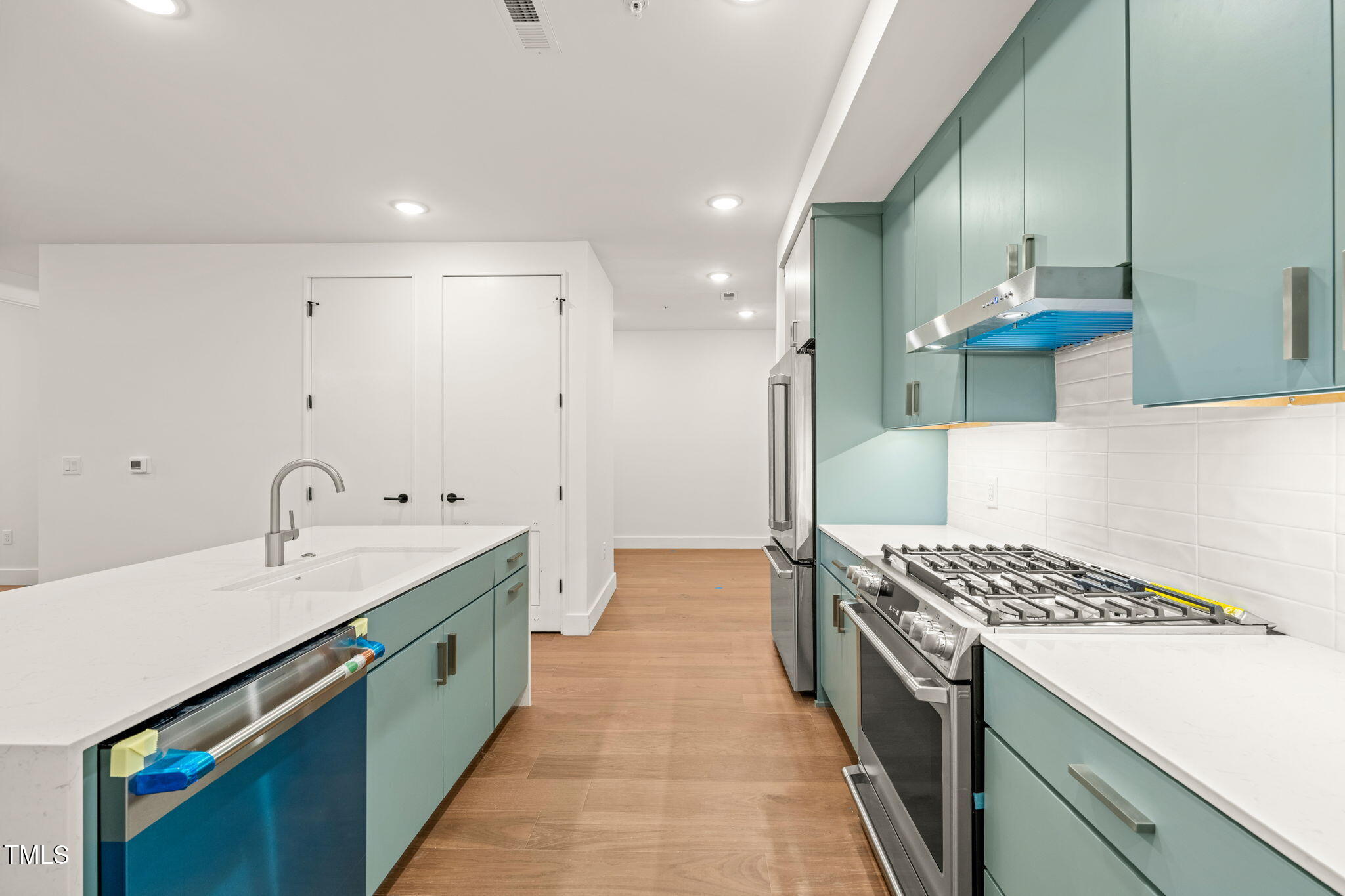 29 Enterprise Street, Unit 209 Raleigh, NC 27607 - Photo 4 of 46 a kitchen with a sink and a stove top oven