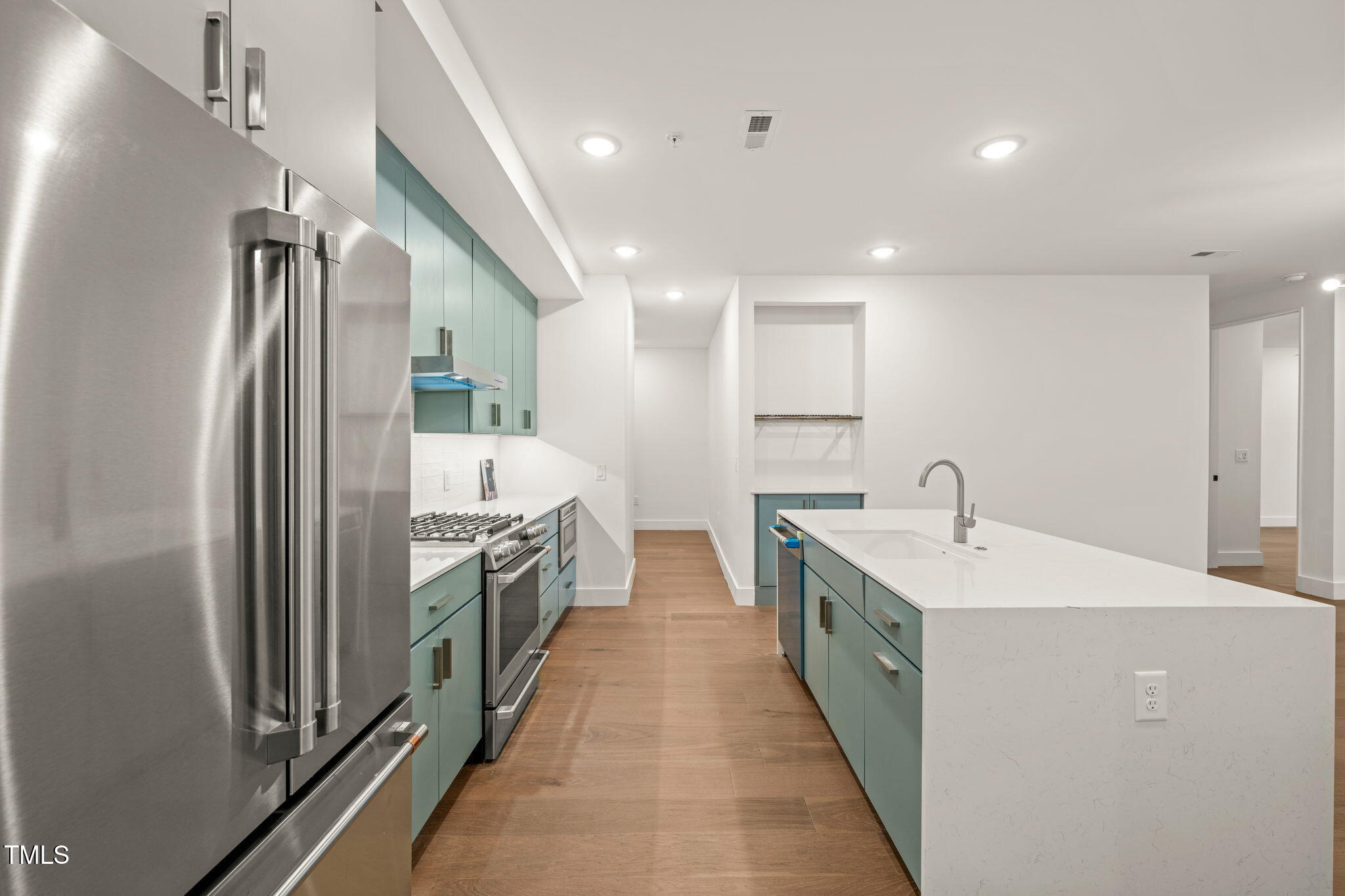 29 Enterprise Street, Unit 209 Raleigh, NC 27607 - Photo 5 of 46 a large kitchen with a large window and stainless steel appliances