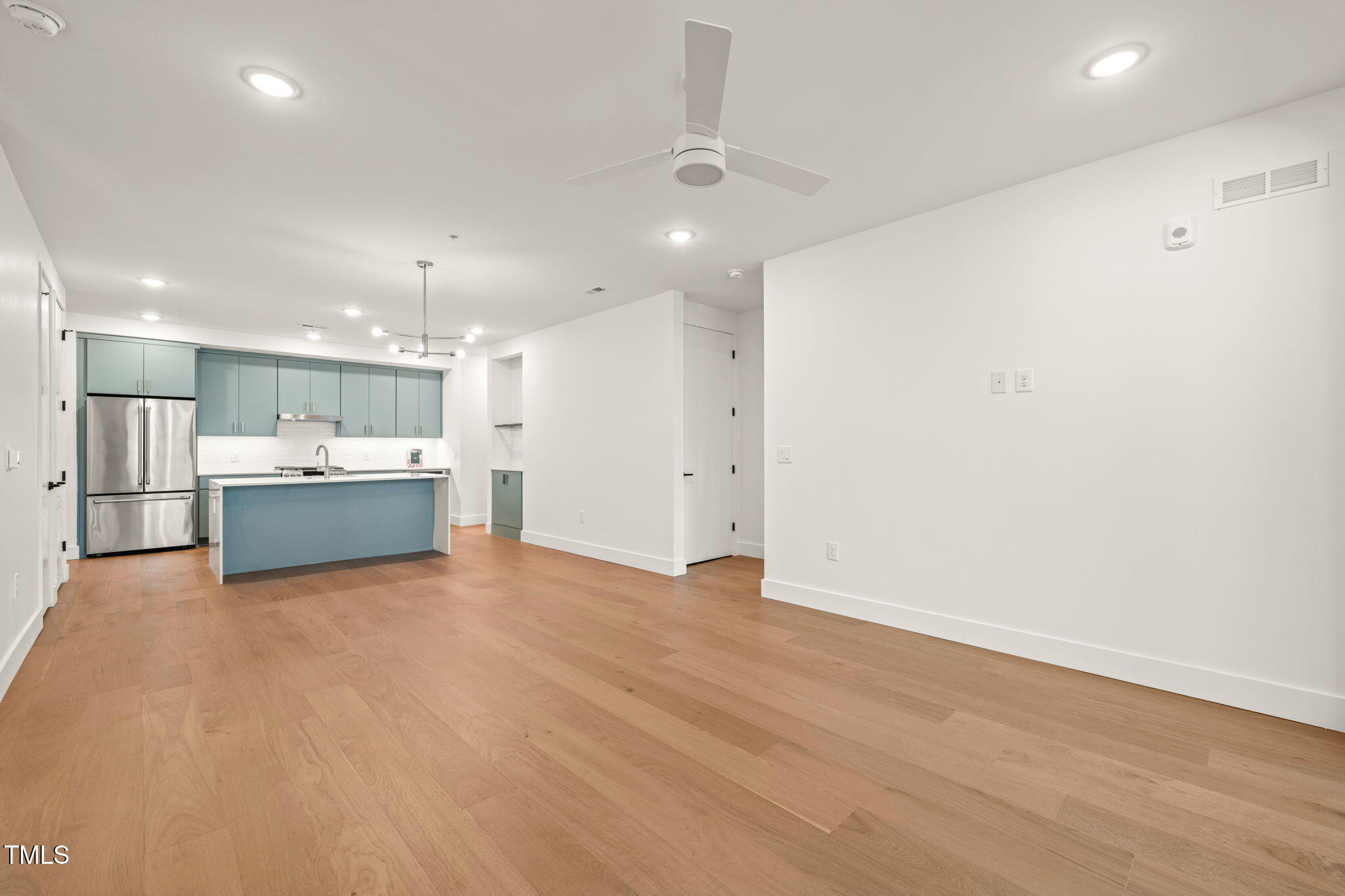 29 Enterprise Street, Unit 209 Raleigh, NC 27607 - Photo 7 of 46 a view of an empty room with a kitchen