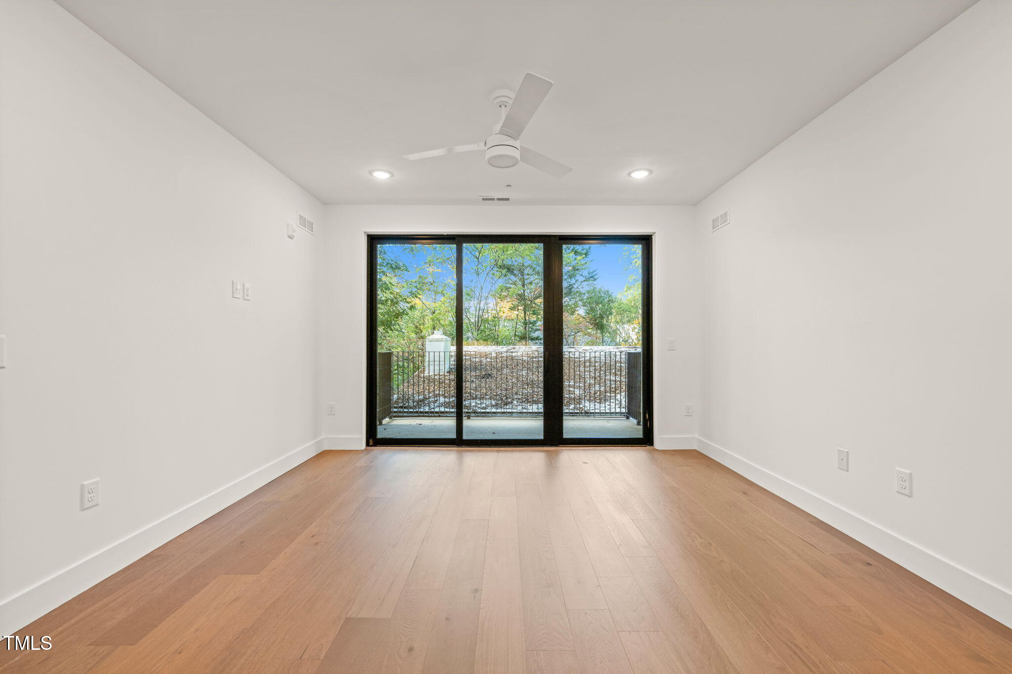 29 Enterprise Street, Unit 209 Raleigh, NC 27607 - Photo 8 of 46 a view of an empty room with wooden floor and a window