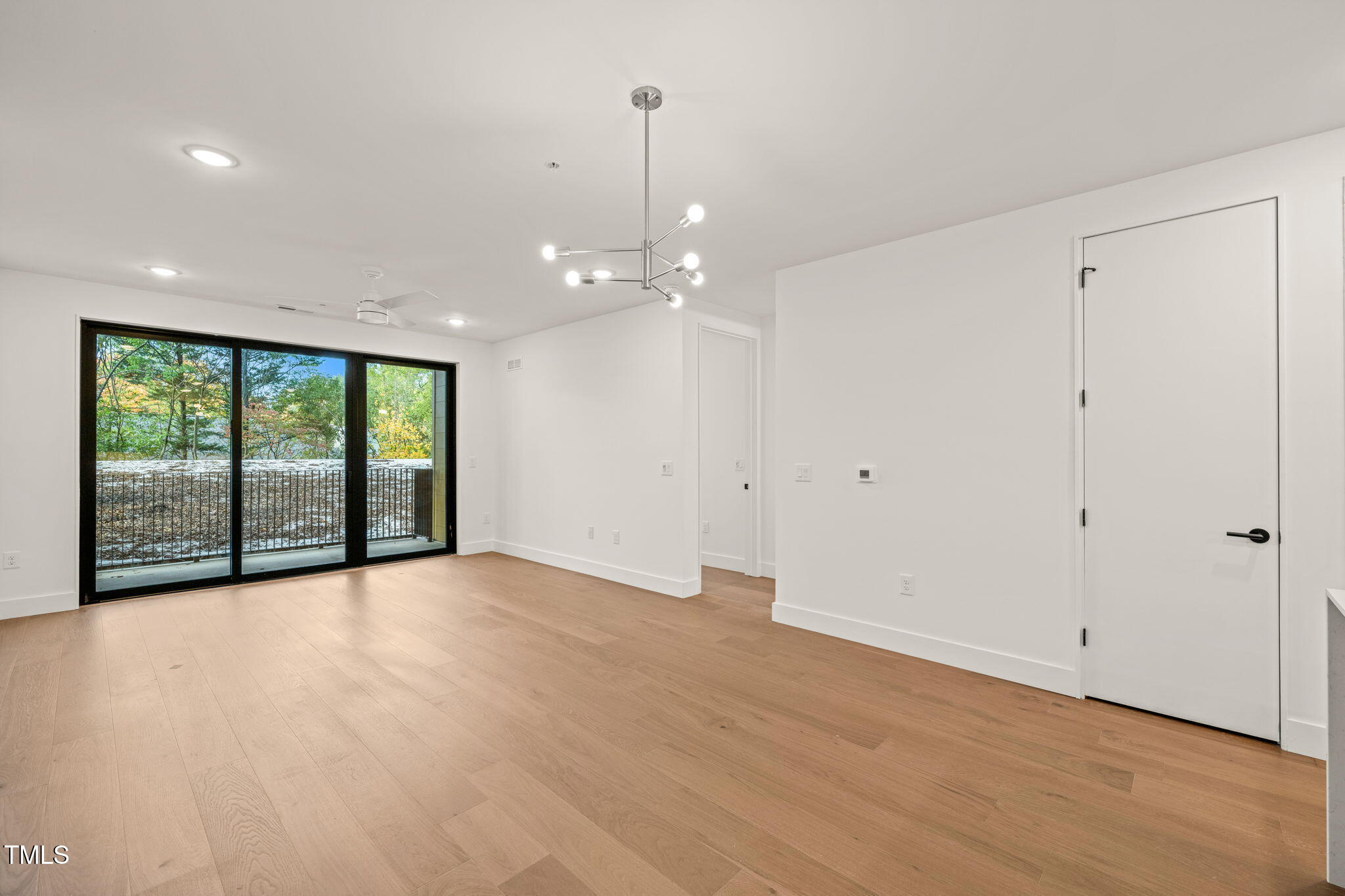 29 Enterprise Street, Unit 209 Raleigh, NC 27607 - Photo 9 of 46 a view of an empty room with glass door