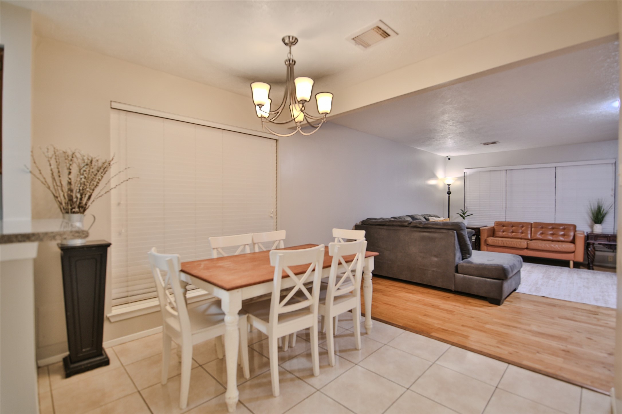 4947 Bridgemont Lane Spring, TX 77388 - Photo 12 of 29 a living room with furniture a chandelier and a dining table