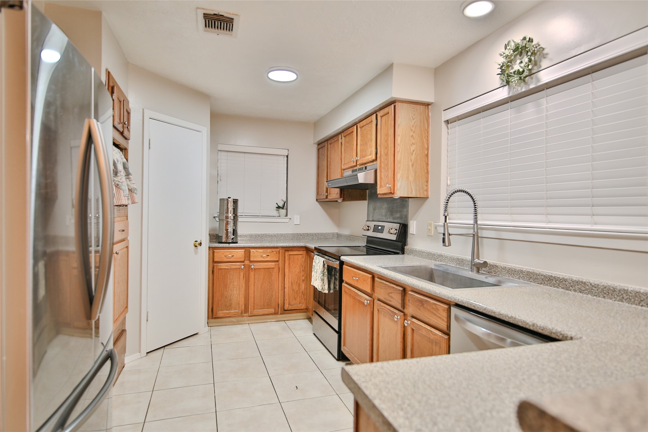 4947 Bridgemont Lane Spring, TX 77388 - Photo 13 of 29 a kitchen with stainless steel appliances granite countertop a refrigerator and a sink