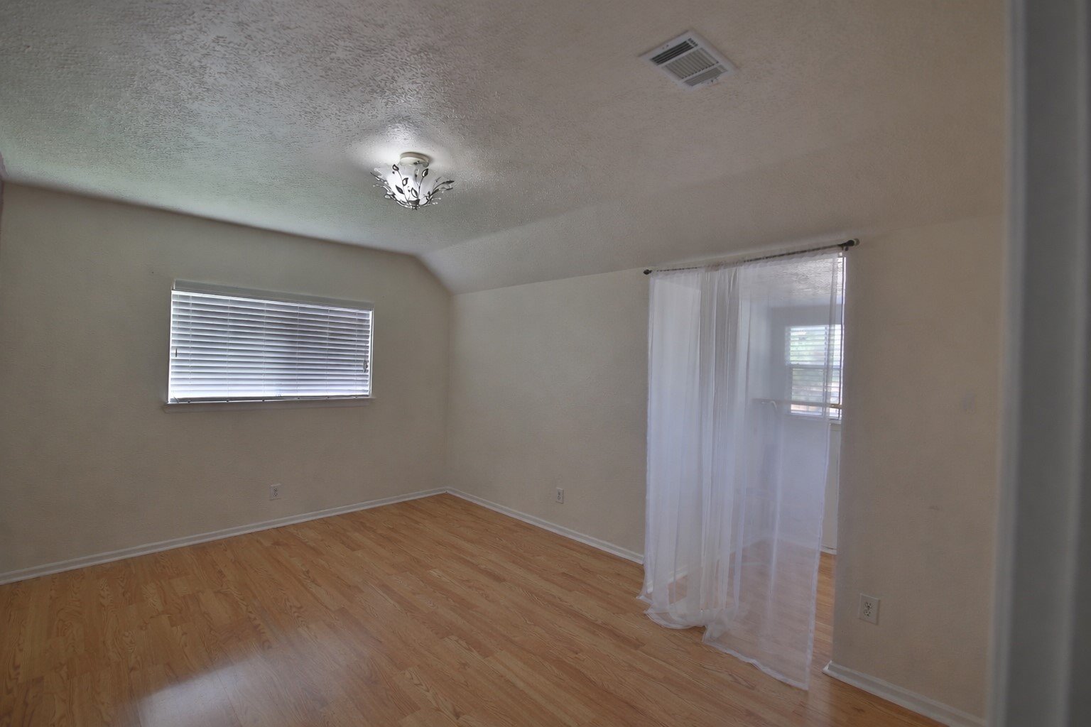 4947 Bridgemont Lane Spring, TX 77388 - Photo 20 of 29 a view of an empty room with wooden floor and a window