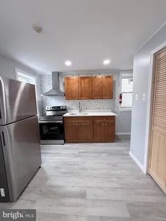 a kitchen with stainless steel appliances a refrigerator and a sink