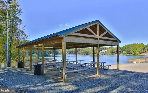 a patio with a table and chairs and potted plants