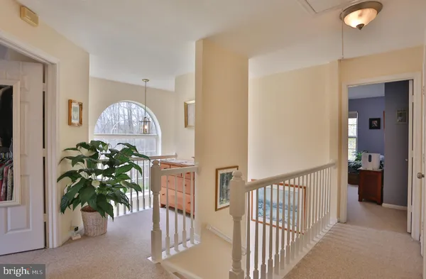 a view of a hallway to a livingroom with furniture