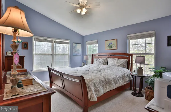a bedroom with a bed and large window