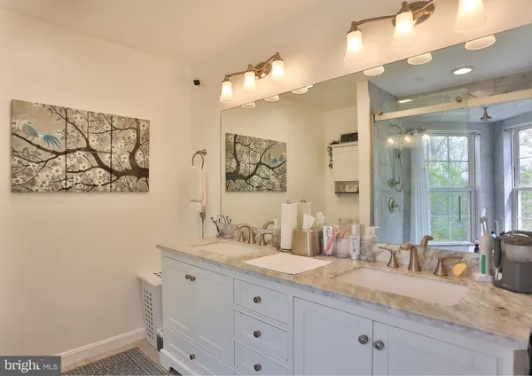 a bathroom with a granite countertop sink mirror and double