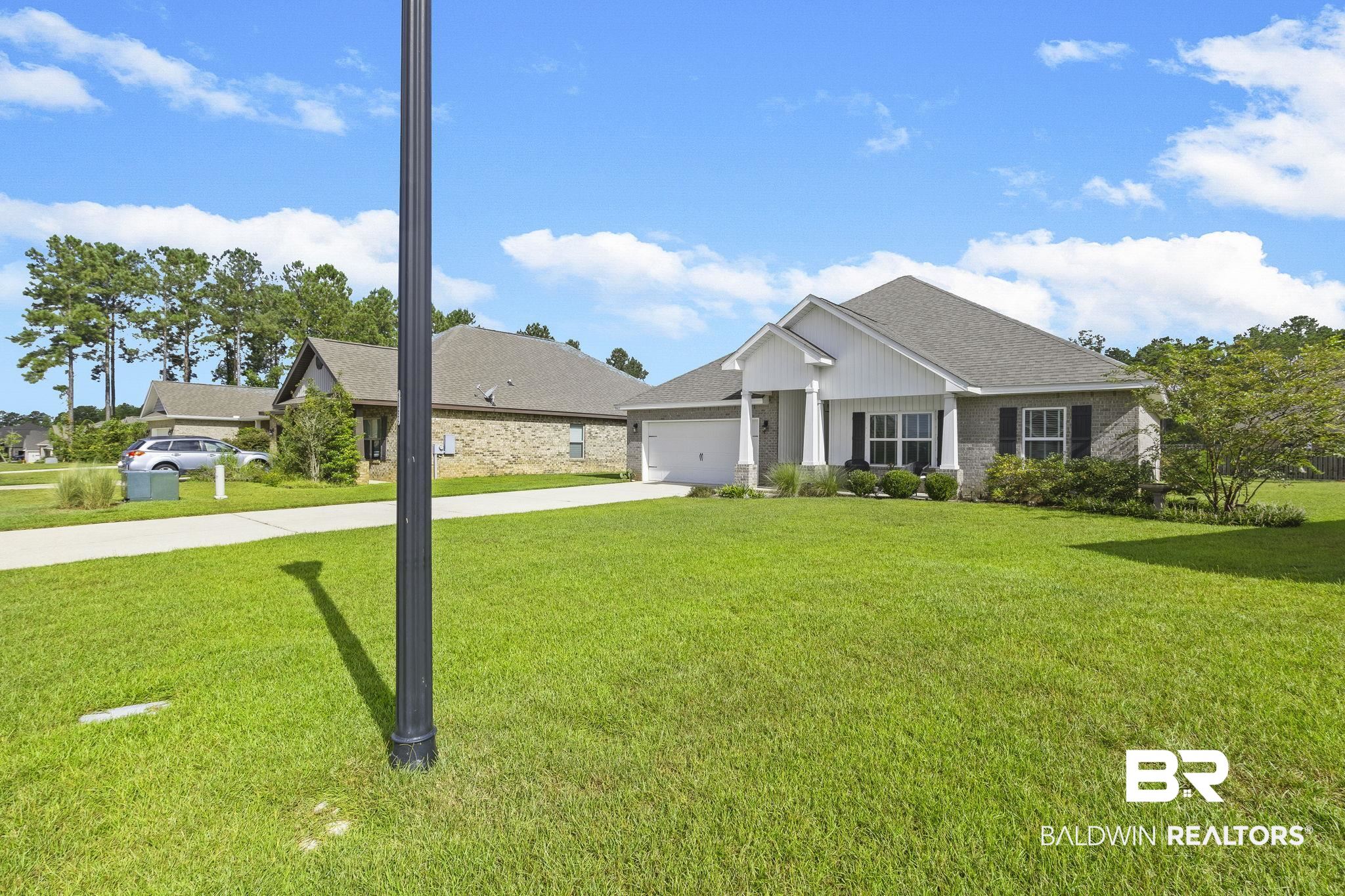 31663 Kestrel Loop Daphne, AL 36527 - Photo 6 of 86 View of front of property featuring a garage and a front yard