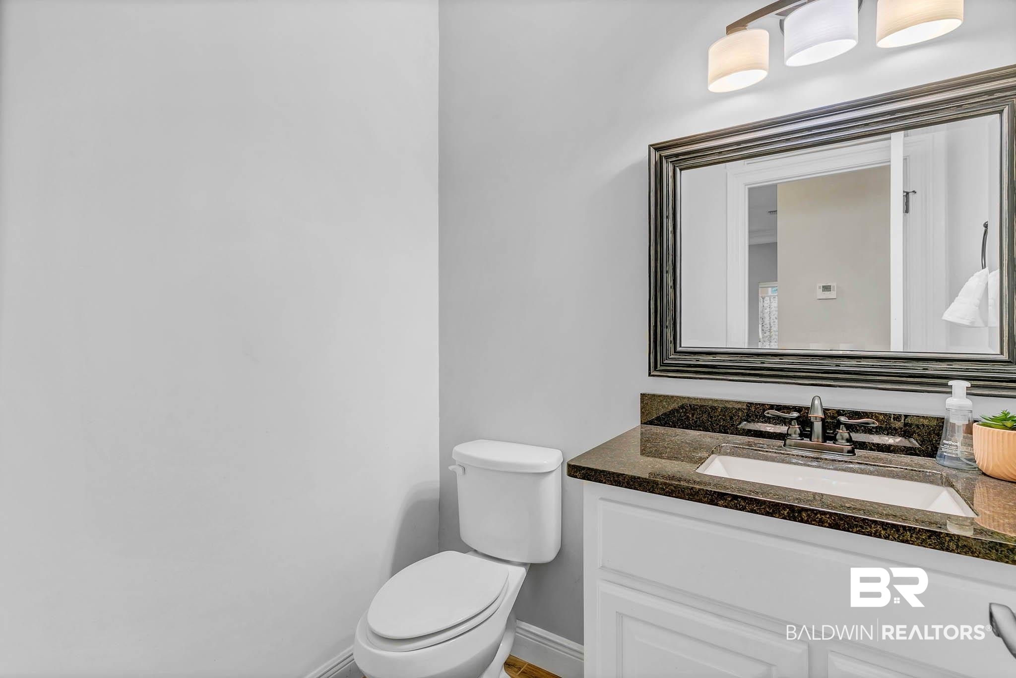 8145 Bay View Drive Foley, AL 36535 - Photo 38 of 81 Half bathroom with toilet and vanity
