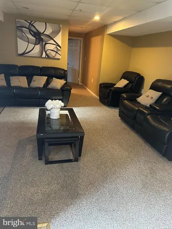 a room with gym equipment and a view of living room