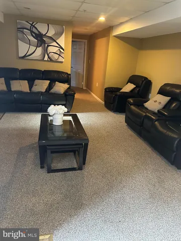 a room with gym equipment and a view of living room