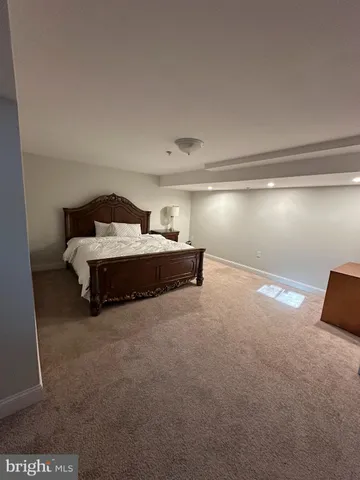 a spacious bedroom with a bed and a window