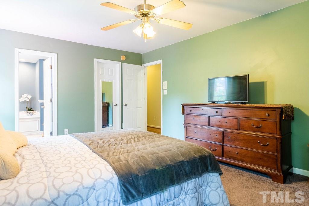 1224 Red Brick Road Garner, NC 27529 - Photo 14 of 30 a bedroom with a bed and a dresser