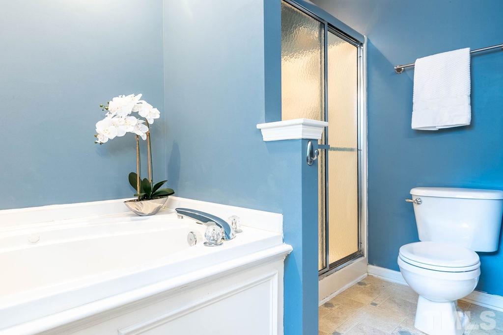 1224 Red Brick Road Garner, NC 27529 - Photo 16 of 30 a bathroom with a sink a toilet and a window