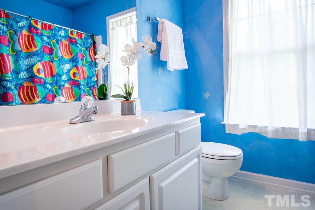 1224 Red Brick Road Garner, NC 27529 - Photo 19 of 30 a bathroom with a sink a toilet and curtain