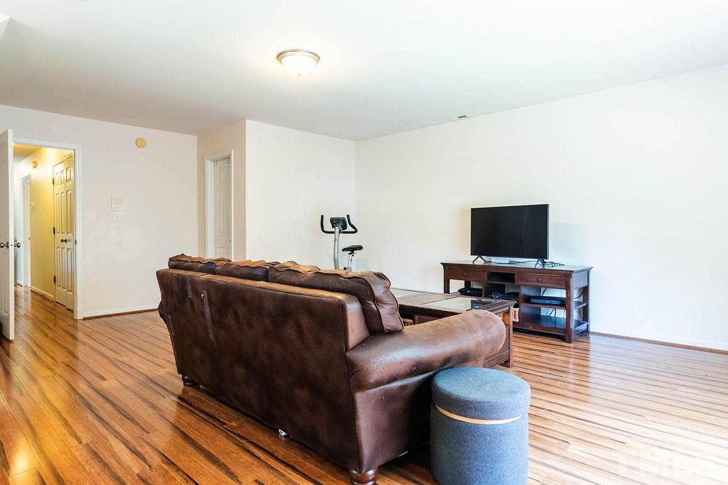 1224 Red Brick Road Garner, NC 27529 - Photo 22 of 30 a living room with furniture and a flat screen tv
