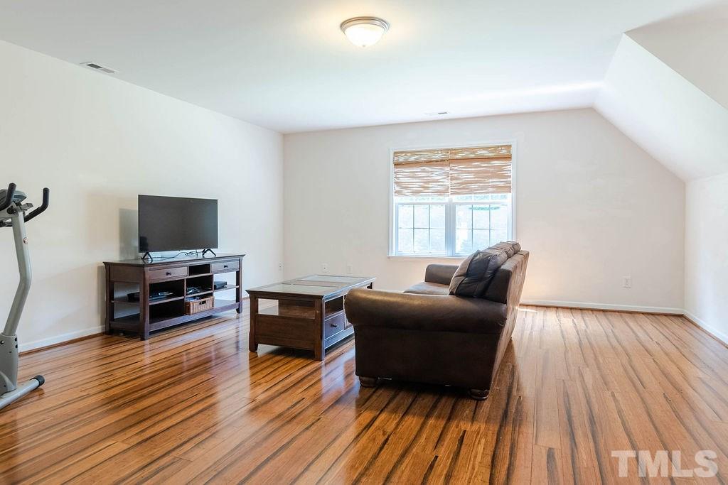 1224 Red Brick Road Garner, NC 27529 - Photo 23 of 30 a living room with furniture and a flat screen tv
