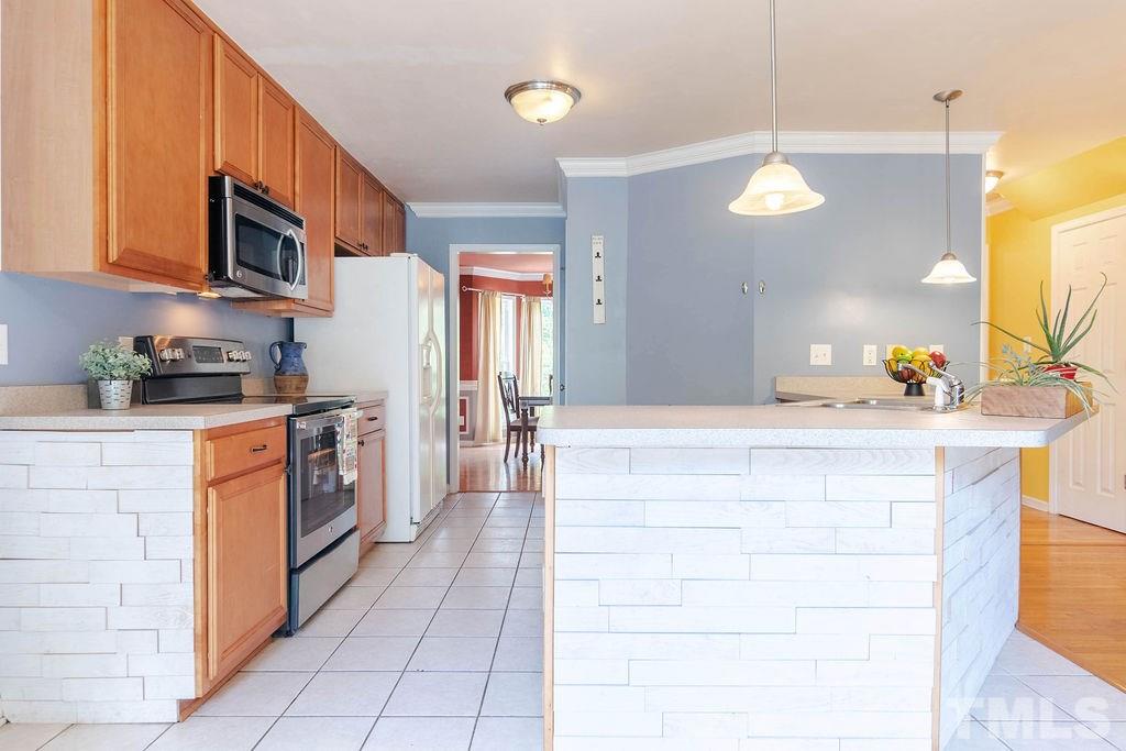 1224 Red Brick Road Garner, NC 27529 - Photo 6 of 30 a kitchen with stainless steel appliances a sink stove and cabinets