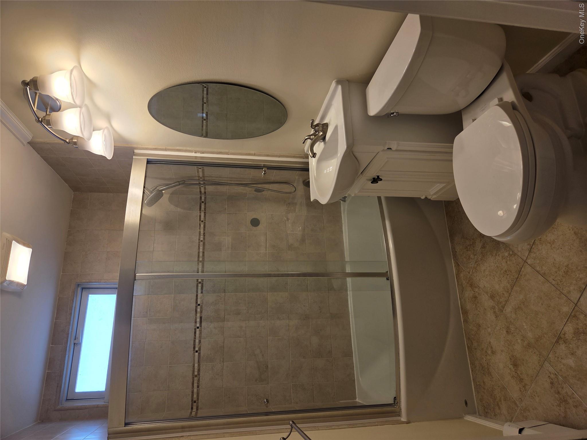 49 Azalea Road Levittown, NY 11756 - Photo 5 of 17 a bathroom with a toilet a sink and shower