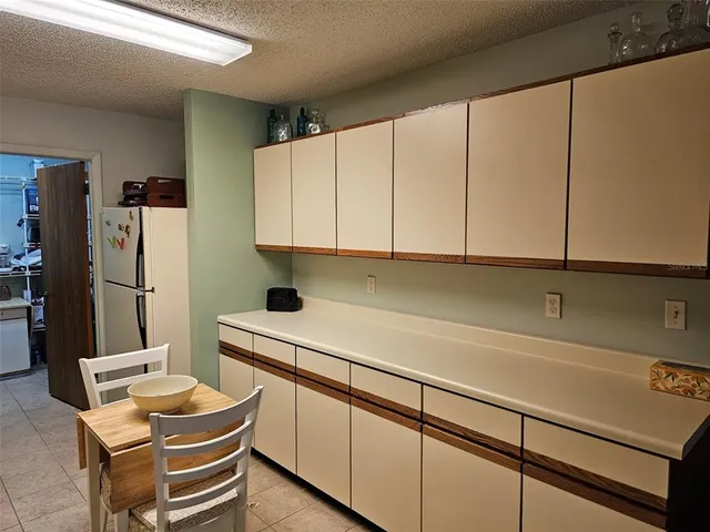 a room with furniture a sink and a refrigerator