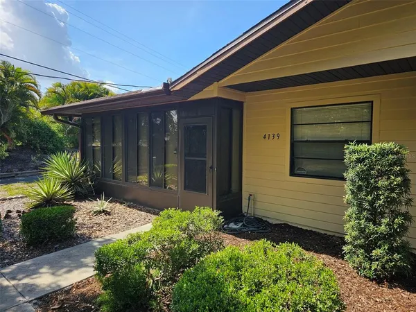 a front view of house with a garden