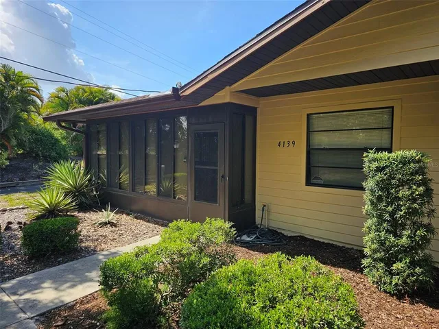 a front view of house with a garden