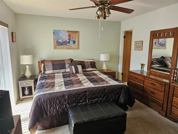 a bedroom with a bed and painting on the wall