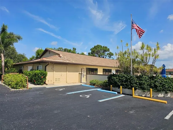 a front view of a house with a yard and potted plants