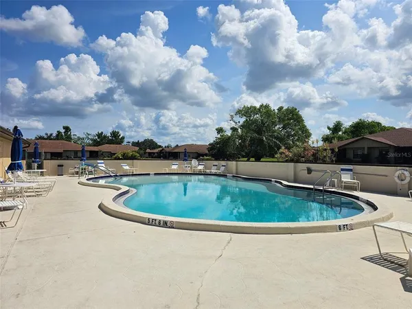 a view of a swimming pool with a yard in back
