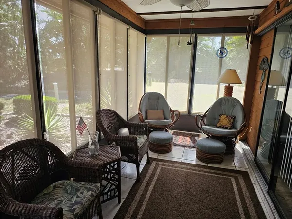 a living room with furniture and a floor to ceiling window