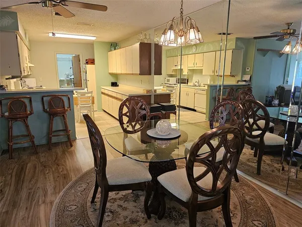 a view of a dining room with furniture and chandelier